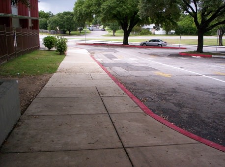 Sloping sidewalk in front of school